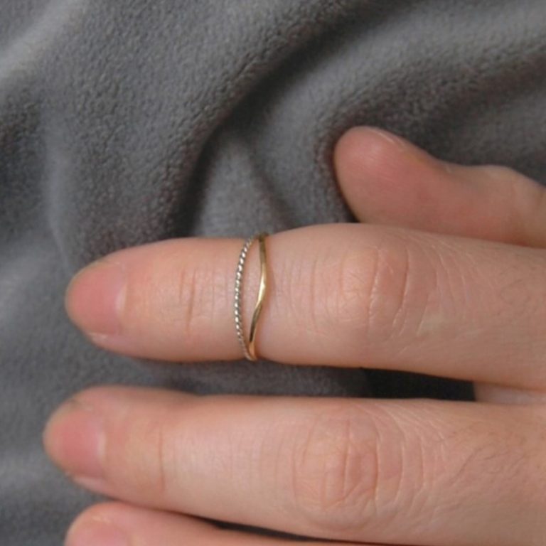 thin gold phalange ring on finger